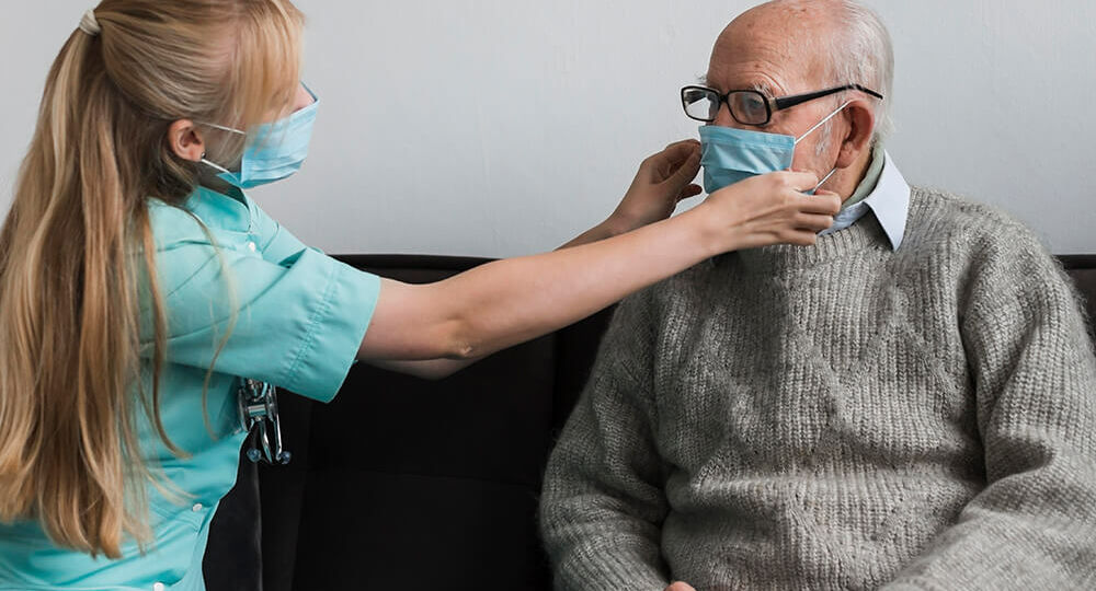 nurse-adjusting-old-man-s-medical-mask-1
