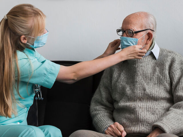 nurse-adjusting-old-man-s-medical-mask-1